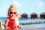 cute little girl drinking cocktail on tropical beach resort